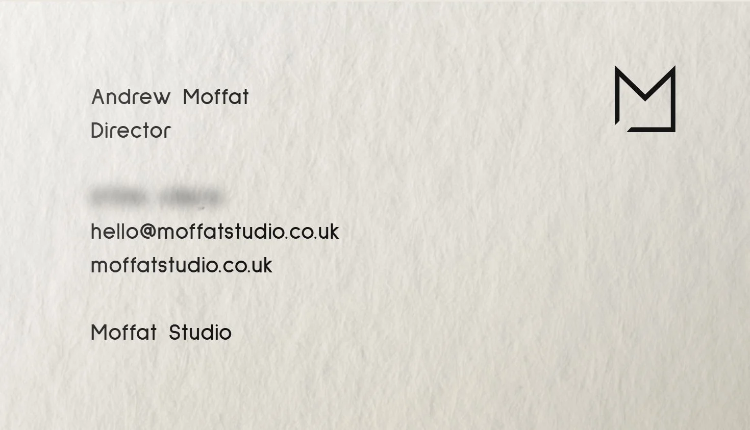 Moffat Studio business card — back, with Andrew Moffat's contact details and the M mark