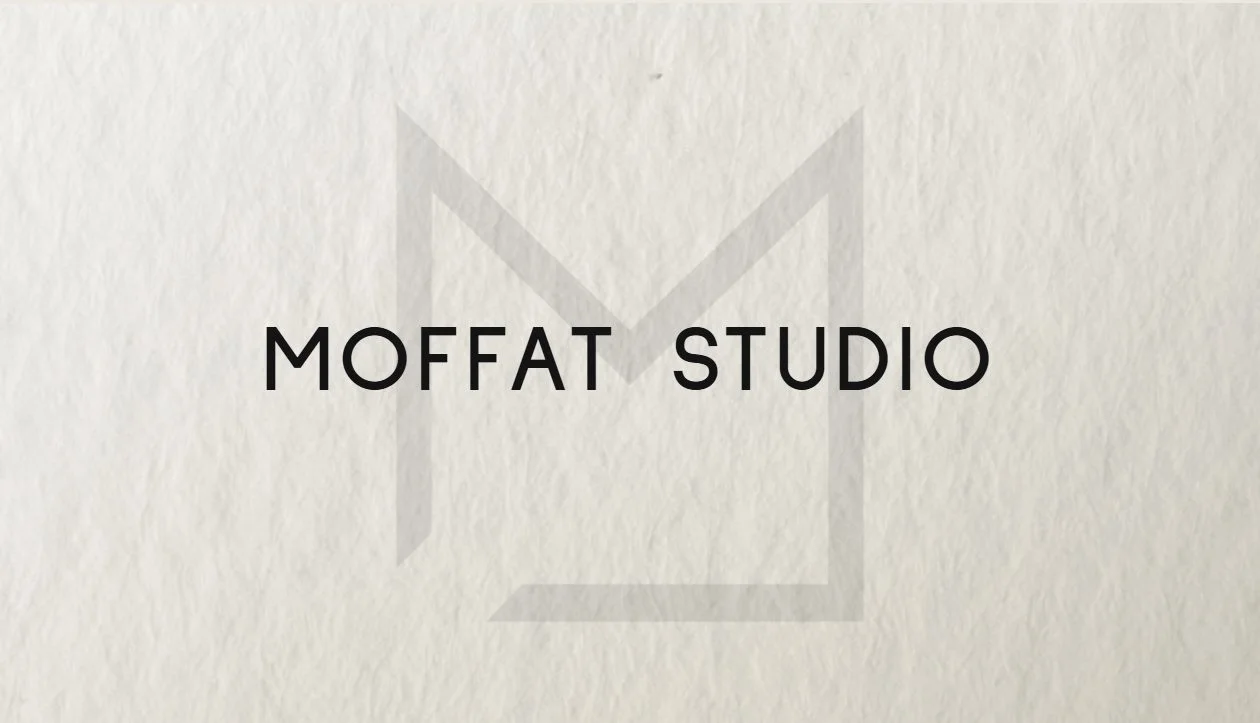 Moffat Studio business card — front, with the studio wordmark over a faded M mark on felt-marked paper stock